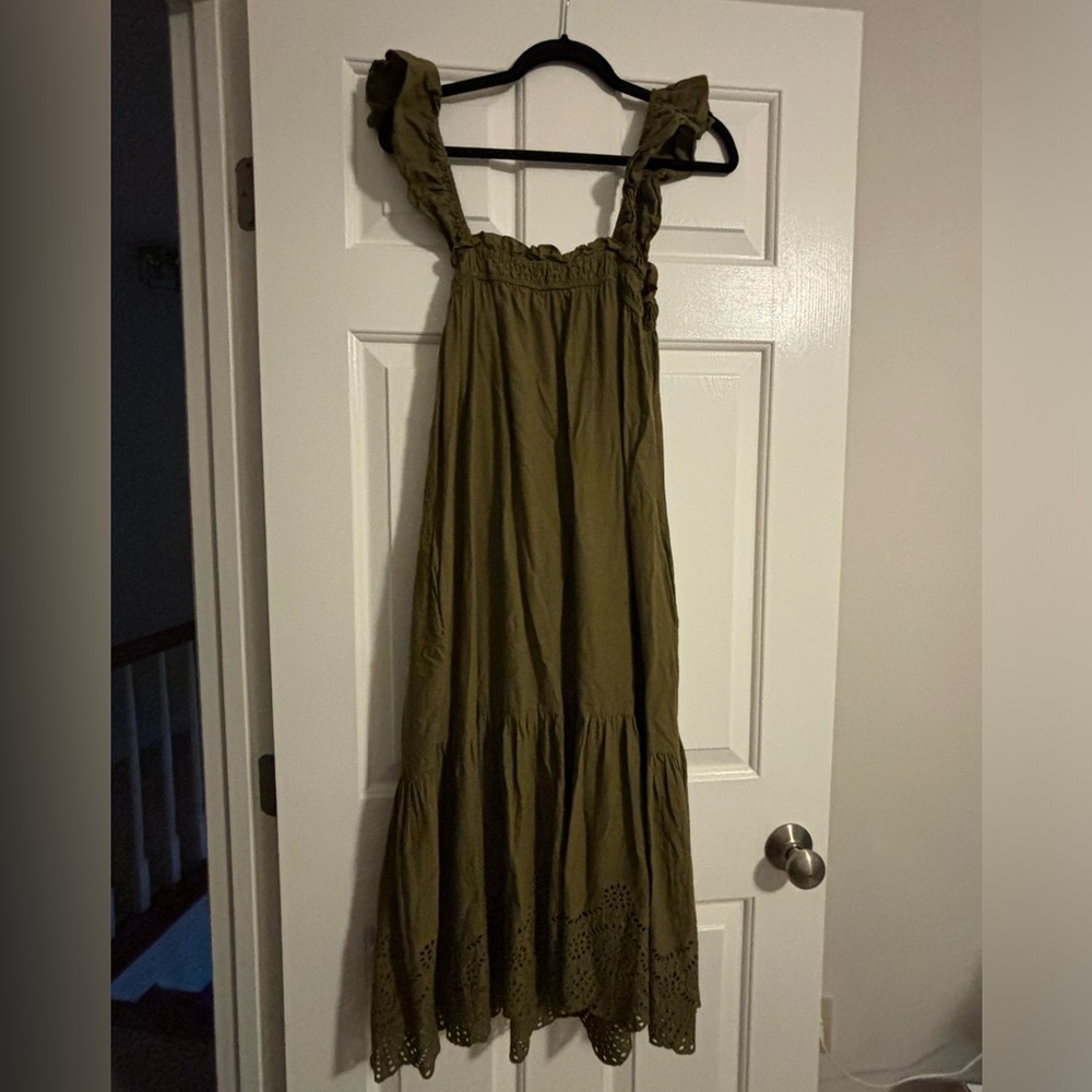 Maxi dress with feminine lace detailing at bottom and ruffle on straps.